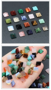Macro view of assorted mini pyramid gemstones on palm and grid for DIY inlay