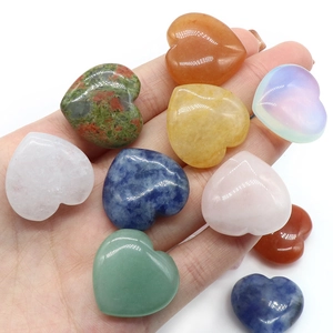 Handheld group of multi-color polished heart-shaped natural crystal and stone ornaments