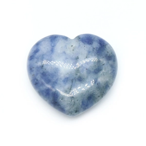 Natural sodalite heart stone with blue and white marble texture on a white background
