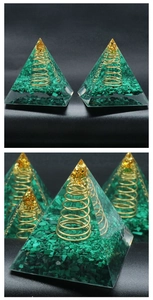 Detailed close-up of malachite orgonite pyramid with copper coil and gold foil elements