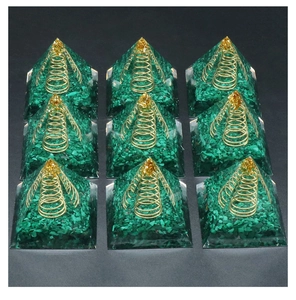 Detailed top view of nine resin Orgone Pyramids with malachite stone and metal spiral coils