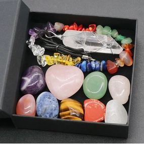 Macro detail of natural crystal healing set with rose quartz heart and gemstones in a gift box