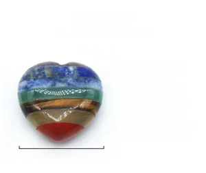 Macro shot of a 30mm heart-shaped 7 chakra stone made of seven layered natural minerals