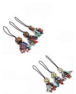 Detail of handmade woven colorful natural crystal stones with Tiger Eye and Citrine pendant