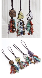 Macro detail of handmade bohemian car pendant with raw natural stones and woven cord