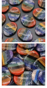 Macro shot of polished 7 chakra worry stone with rainbow natural crystal layers