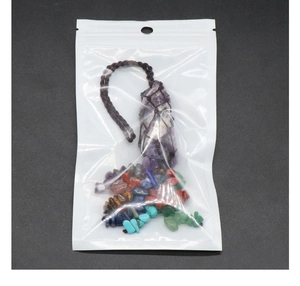 Detailed set of natural crystal healing stones in a brown woven mesh net pouch