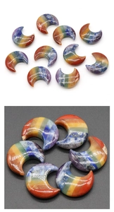 Macro detail of crescent moon polished chakra crystals with rainbow layered gemstones