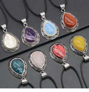 Macro detail of teardrop gemstone pendants with hollow retro silver alloy settings