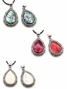 Three teardrop shell pendants in abalone, red and white shell with silver ornate borders