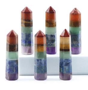 Macro shot of hexagonal chakra crystal wands with seven layered natural gemstones