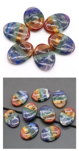 Detailed macro view of smooth polished oval 7 chakra healing crystal stones for meditation