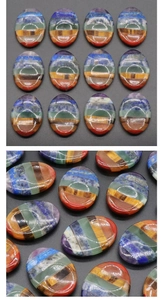 Detailed macro view of seven chakra layered crystals showing smooth oval worry stone textures
