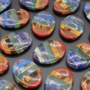 Polished chakra worry stones with seven colorful natural crystal layers in oval shape