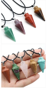 Various conical natural stone pendants shown held in hand to demonstrate scale and size