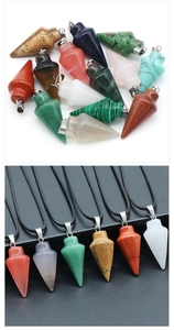 Detailed view of various colorful gemstone cone pendants on white and black backgrounds
