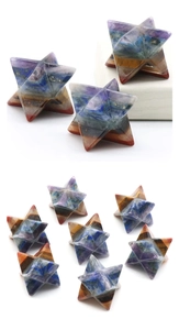 Macro shot of colorful seven chakra Merkaba star carved from layered natural crystal stones
