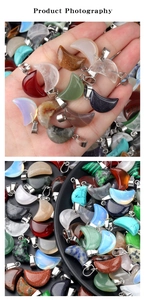 Macro shot of assorted crescent moon gemstone pendants with silver metal bails on a black tray
