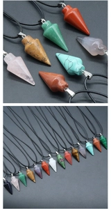 Macro shot of assorted cone-shaped natural stone pendants with black cord and metal clasp