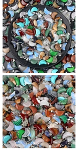 Macro shot of colorful moon-shaped crystal charms with metallic hooks for DIY jewelry making