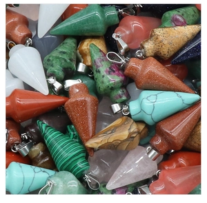 Macro detail of various polished natural crystal cone pendants with metallic silver bails