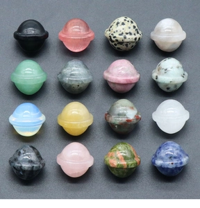 Macro display of 16 assorted natural crystal Saturn planetary stone carvings in a grid