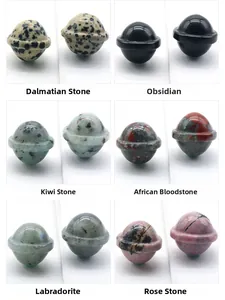 Macro view of six natural gemstone planet carvings including Obsidian and Rose Quartz
