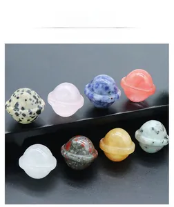 Macro shot of assorted natural gemstone planet figurines with polished Saturn rings