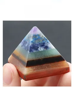 Detailed close-up of a 30mm natural seven chakra layered crystal pyramid ornament