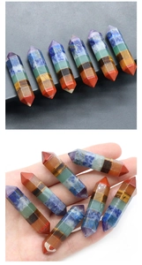 Macro detail of a 10x42mm hexagonal chakra crystal wand with seven color layers