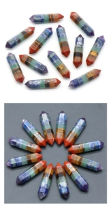 Detailed view of dual-pointed hexagonal chakra crystal prisms in various vibrant stones
