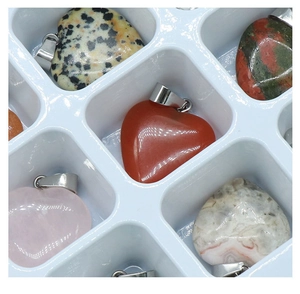 Macro view of assorted heart-shaped natural stone pendants with silver metal clasps