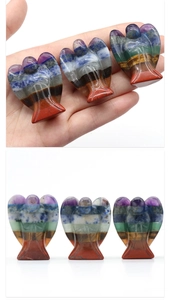 Detailed view of hand-held and lined seven chakra crystal angel statues in various colors