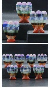 Macro detail of hand-carved seven chakra natural crystal angel figurines with stone layers
