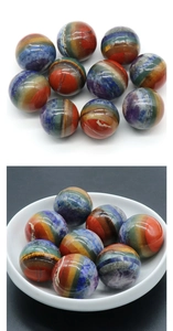 Polished seven chakra natural crystal stone ball with colorful layered stripes detail