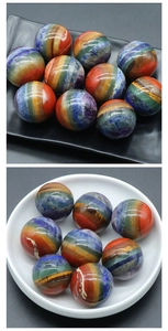 Detailed view of polished rainbow seven chakra natural stone spheres on display dishes