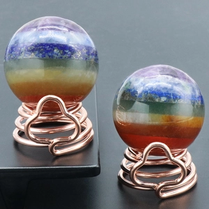 Polished seven chakra natural crystal ball on a rose gold spring stand decoration