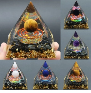 Detailed macro view of Orgone energy pyramids with tiger eye and gold foil inside