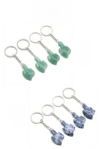 Detail view of natural aventurine and sodalite stone hand gesture charms for keychains