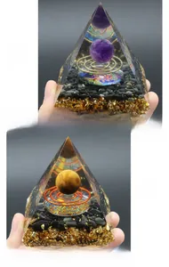 Detailed comparison of Orgonite pyramids with Amethyst, Tiger Eye, and Tree of Life symbol