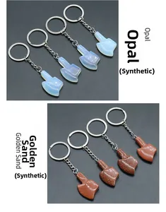 Detail view of synthetic opal and goldstone axe keychains with metal ring attachments