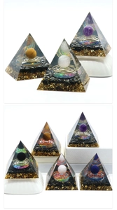 Detail view of handmade orgone energy pyramid with crystal ball and gold foil layers