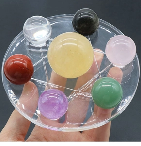 Close-up of seven natural crystal spheres on an acrylic hexagram stand for home decor