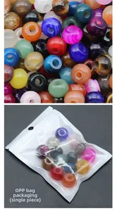 Macro detail of large hole natural crystal agate beads in transparent OPP bag packaging