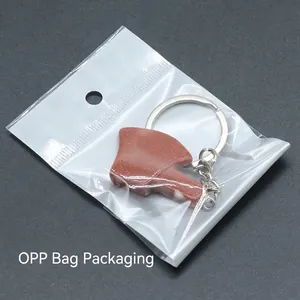 Natural agate crystal axe-shaped keychain pendant with shimmering reddish-brown texture
