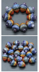 Macro shot of tiered seven chakra natural stone acorns for energy healing and DIY crafts