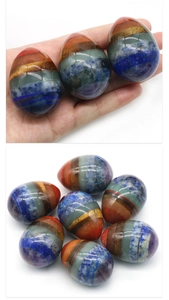 Close-up of a 48mm chakra egg made from seven layered colorful natural energy stones