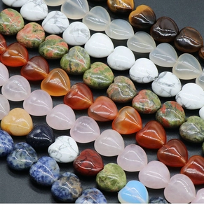 Macro shot of assorted heart-shaped semi-precious stone beads with polished texture