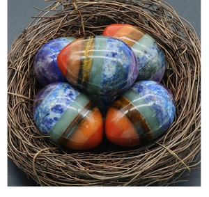 Detailed close-up of a chakra gemstone egg crafted with layered natural tiger eye and crystals