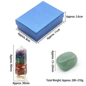 Healing set with colorful crystal pillar and green raw stone in a gift box